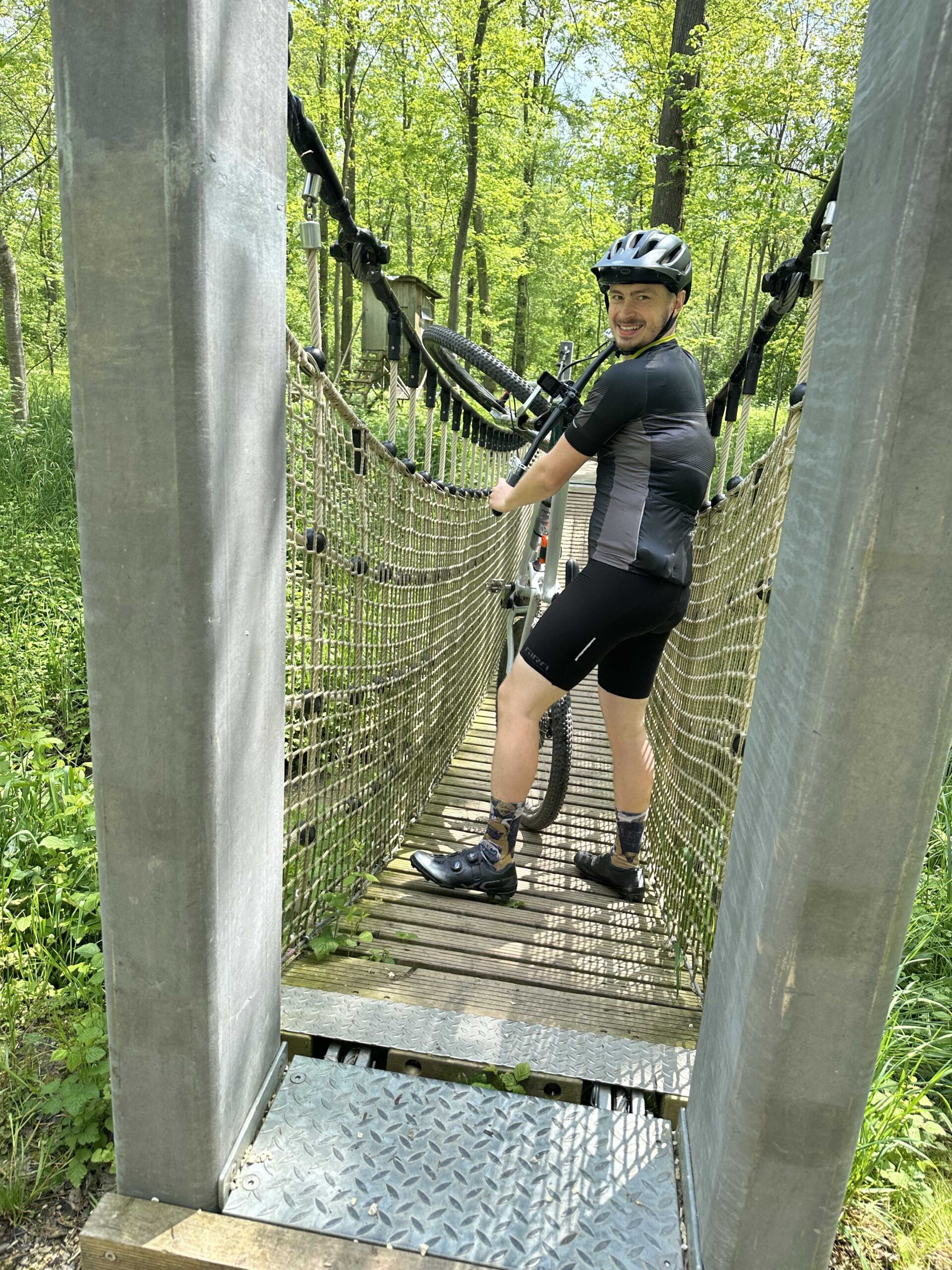 Julius mit Mountainbike auf einer Hängebrücke im Wald